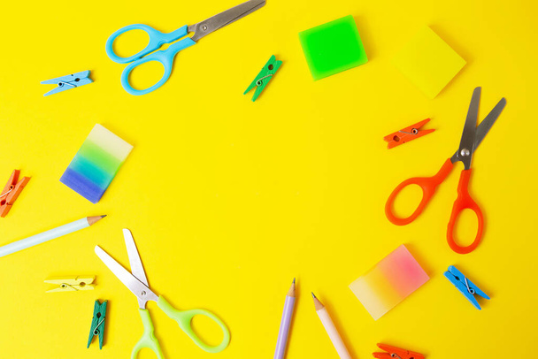 Top view of office stationery on yellow background.Open composition with negative space. - Valokuva, kuva