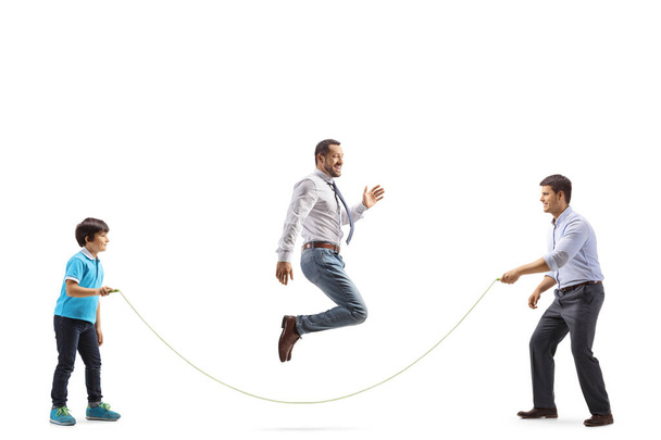 Boy and adults playing a skipping rope isolated on white background - Φωτογραφία, εικόνα