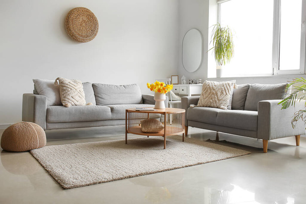 Interior of modern living room with cozy sofas and flower vase on coffee table - Fotoğraf, Görsel