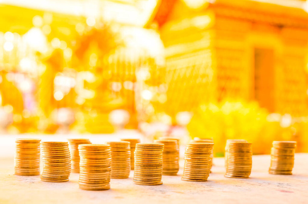 Row of coins with yellow bokeh, Thailand. - Foto, imagen