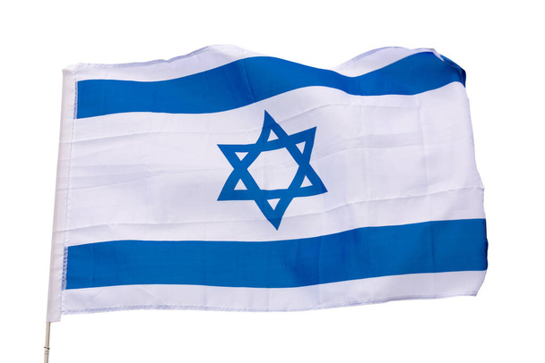 Canvas of flag of Israel flutters on flagpole against gray sky.Close-up, on gray background - Zdjęcie, obraz