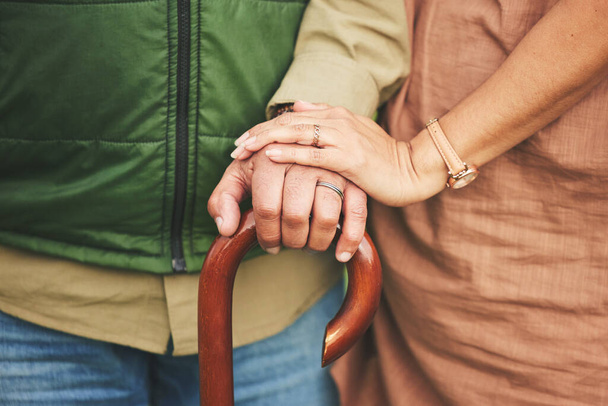 Closeup, hands and couple with support, cane and retirement with solidarity, marriage or appreciation. Zoom, touching or senior man with old woman, love or care with empathy, understanding or comfort. - Photo, Image