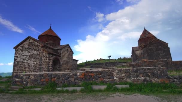 Scenic view of old Sevanavank church in Sevan, Armenia on sunny blue sky day. Sevanavank monastery complex on peninsula on northwestern shore of Lake Sevan in Armenia - Footage, Video