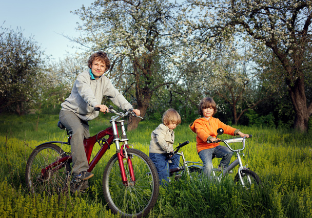 three brothers ride bikes - Photo, Image