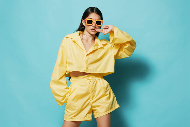 woman yellow attractive lifestyle brunette stylish creative background joy model monochrome fashion sunglasses trendy lovely summertime young cheerful smile girl beautiful - Photo, Image