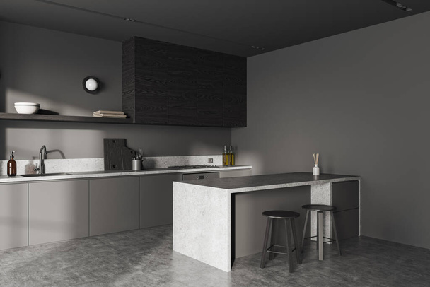 Dark home kitchen interior with stone bar island, side view stool on grey concrete floor. Cooking corner with kitchenware and shelves with sink and stove. 3D rendering - 写真・画像