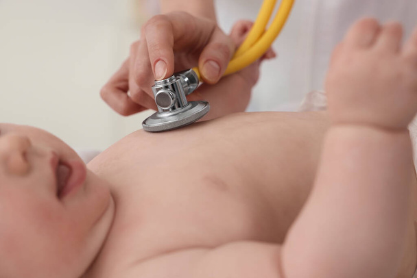 Pediatrician examining little baby with stethoscope in clinic, closeup - Foto, immagini