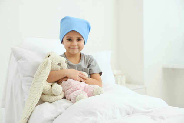 Childhood cancer. Girl with toy bunny in hospital - Fotografie, Obrázek