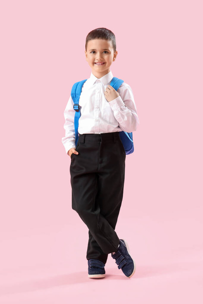 Little schoolboy with backpack on pink background - Фото, зображення
