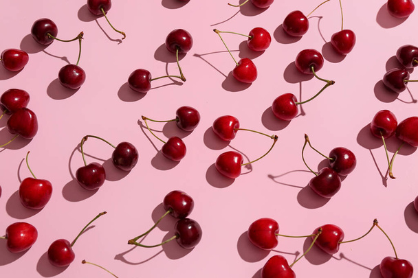 Many sweet cherries on pink background - Foto, Imagen