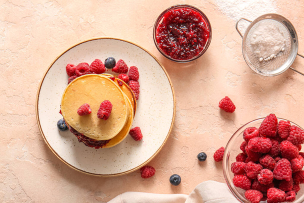 Plate of tasty pancakes with raspberries on beige background - Φωτογραφία, εικόνα