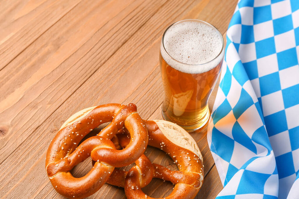 Flag of Bavaria, mug with beer and pretzels on wooden background - Фото, зображення