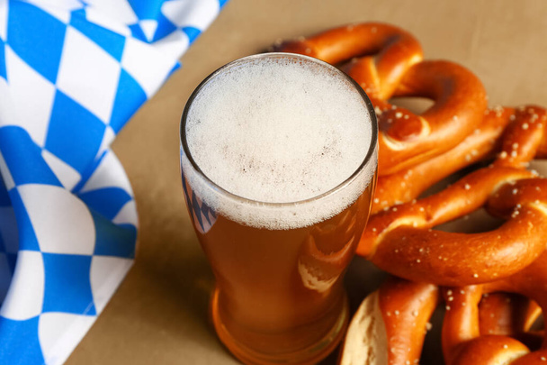 Flag of Bavaria, mug with beer and pretzels on brown background - Photo, image