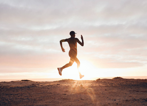 Sunset, running and silhouette with woman in nature for health, workout and fitness challenge. Performance, sports and exercise with runner training in outdoor for speed, marathon and wellness mockup. - Foto, imagen