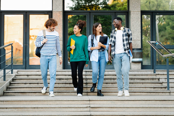 Студентські друзі міжнародного коледжу розмовляють і виходять з університетських сходів
 - Фото, зображення
