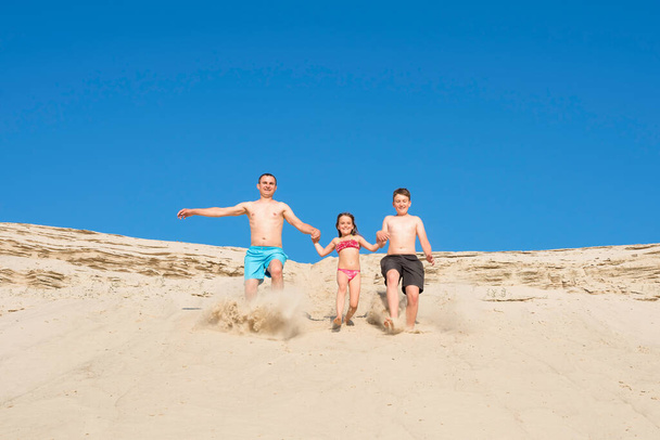 Happy family on a beach vacation have fun playing on the sand. Travel and leisure. Concept about sports and active games in summer - Foto, immagini