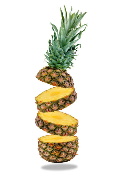Flying fresh ripe pineapple slices isolated on a white background. Close-up. - 写真・画像