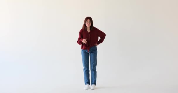 A spirited Caucasian teenage girl, against a backdrop of a white screen, she takes the spotlight and captivates viewers with her lively conversation skills. - Footage, Video
