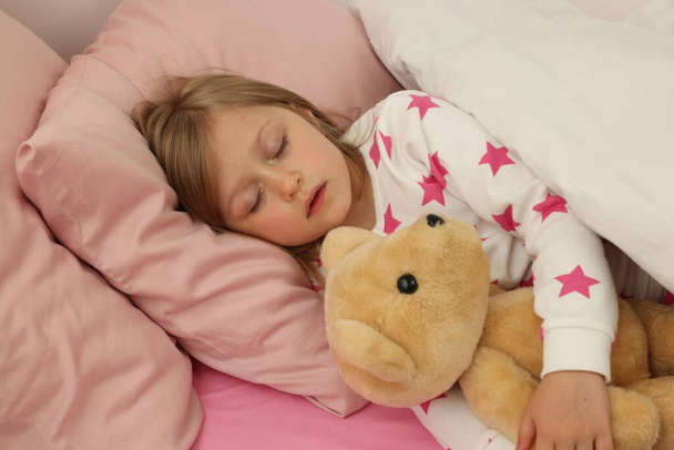 Little girl snoring while sleeping in bed - Photo, image