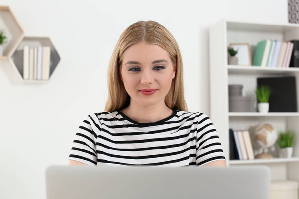 Home workplace. Woman working on laptop in room - Zdjęcie, obraz