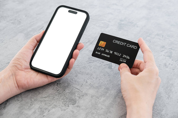 woman shopping online and pay on the mobile phone application with the green credit card. flat lay and modern style. - 写真・画像