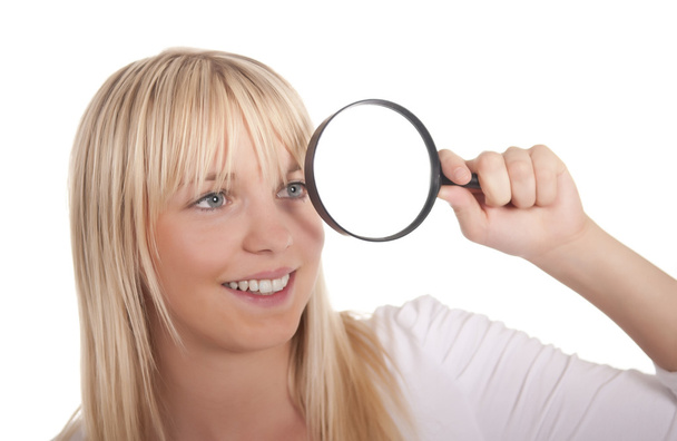 Young woman with magnifying glass - Foto, imagen
