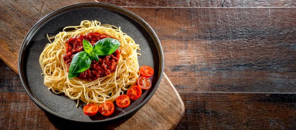 Composition with a plate of spaghetti bolognese. - Photo, Image