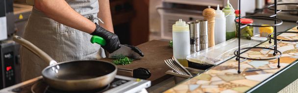 Cook cutting greens for gourmet dish served at fine dining restaurant - Foto, Bild