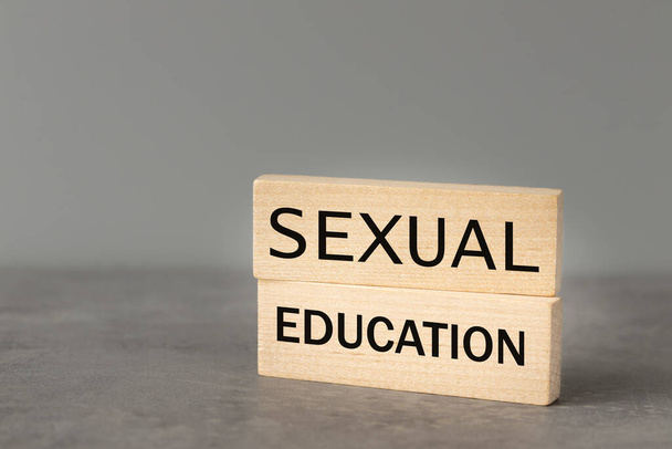 Sexual education, Wooden blocks with the words "Sexualan Education" Beautiful gray background, The concept of sex education of young people, copy space - Фото, изображение