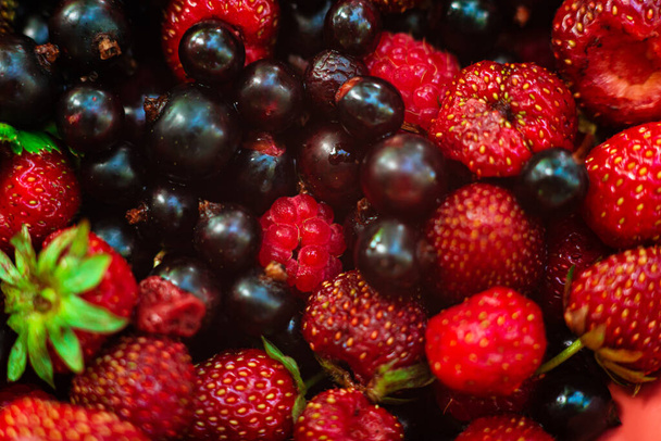 Ripe fragrant bright summer berries strawberries, currants, strawberries close-up. Juicy, appetizing look. Background with ripe berries. Desktop wallpaper. Top view. Macro - Φωτογραφία, εικόνα