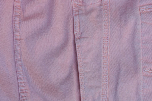 Cebi olan pembe pamuk kumaş deseni ve kıyafetlerin üzerindeki ceketin dikişleri - Fotoğraf, Görsel