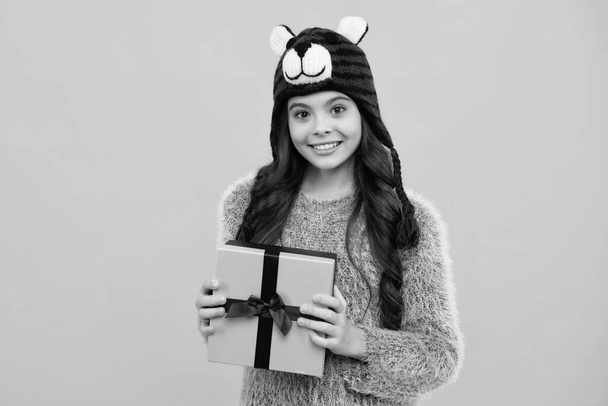 Happy teenager, positive and smiling emotions of teen girl. Funny kid girl in winter wear holding gift boxes celebrating happy New Year or Christmas. Winter holiday - Foto, imagen