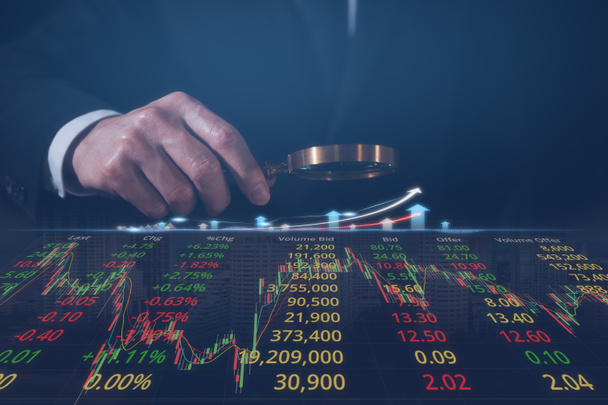 Podnikatel drží lupu zkoumání skla obchodní graf Stock data pro analýzu trhu a finanční strategie - Fotografie, Obrázek