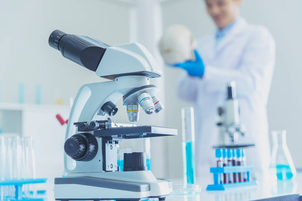 Science microscope equipment in biology chemical laboratory. Scientific experiment Microscope on Lab table microbiology equipment. Chemistry objects on lab background. Chemistry scientific concept - Photo, Image