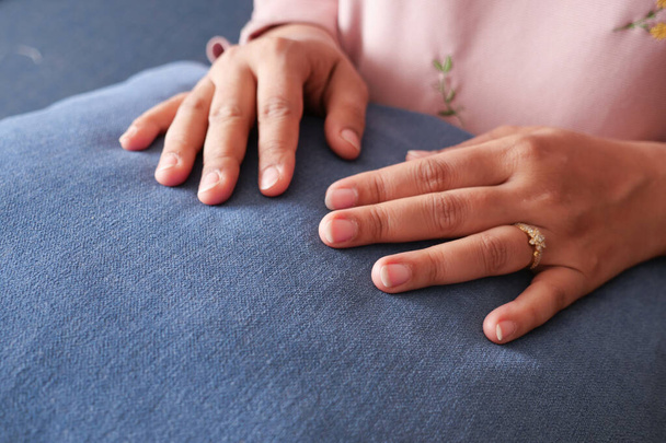  women hand on gray color pillow . - Foto, imagen