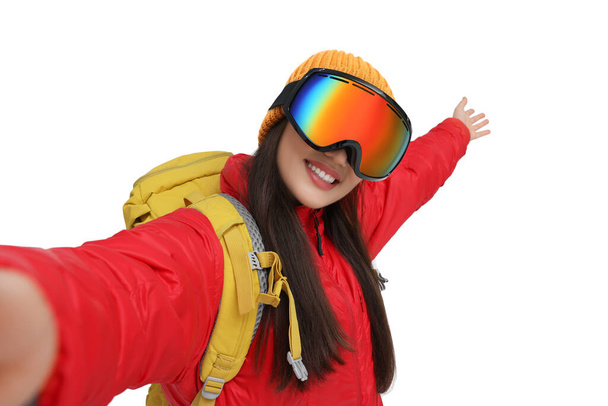 Smiling woman in ski goggles taking selfie on white background - Фото, изображение