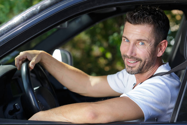 portrait of a handsome man in car - 写真・画像
