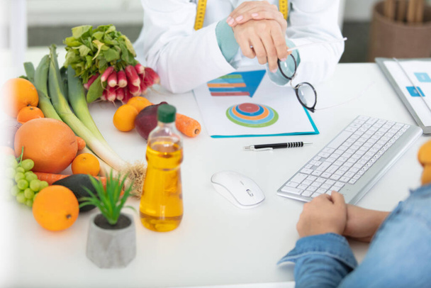nutritionist doing a personalized diet plan for a patient - Foto, afbeelding