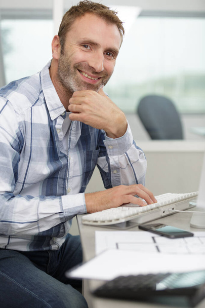 casual man working on computer in office - Photo, image