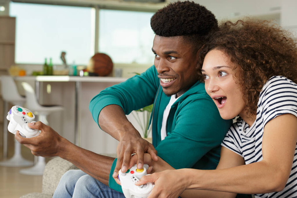 young couple playing video game - Fotó, kép