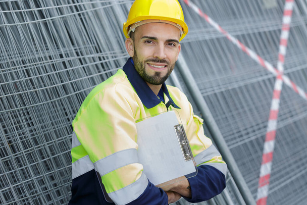 smiling construction manager standing on building site - Fotografie, Obrázek