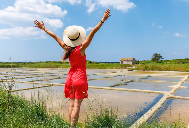 Woman with open arms looking at salt marsh in France- Guerande- Loire Atlantique - Фото, зображення