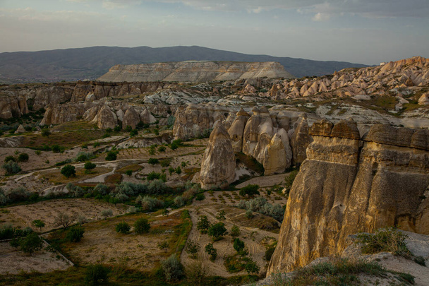 Fantastic spring view of Cappadocia, cloudy overcast beautiful sky. Beautiful valley morning scene in May. - Foto, immagini