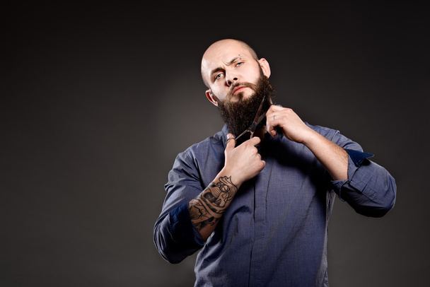 Bald man with a beard cut off his beard - Photo, Image