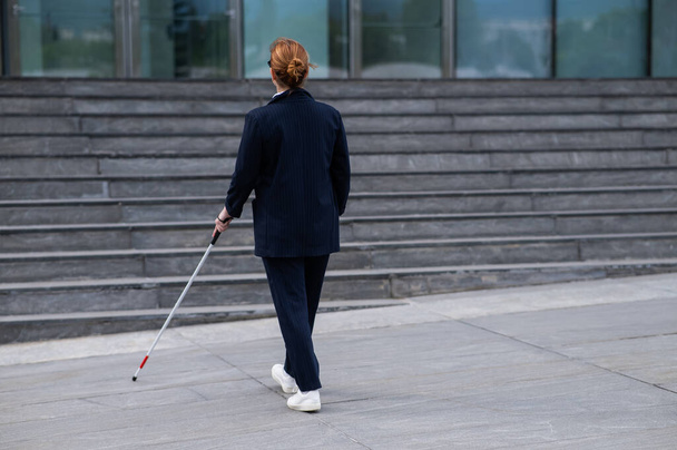 Blind businesswoman walking with tactile cane to business center - Φωτογραφία, εικόνα