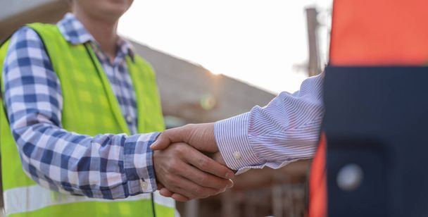 Construction worker team hands shaking greeting start up plan new project contract in office center at construction site, industry ,architecture, partner, teamwork, agreement, property, contacts. - Φωτογραφία, εικόνα