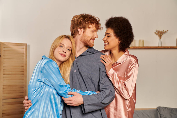 open relationships, happy man with red hair hugging interracial women, cultural diversity, non traditional partners, multicultural people, acceptance and understanding, happiness  - Photo, Image