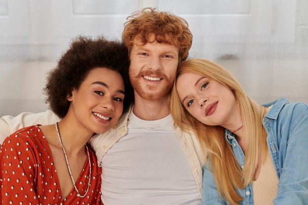 modern family, polygamy concept, freedom in relationship, cultural diversity, portrait of redhead man and multicultural women looking at camera, polyamorous lifestyle, non traditional lovers  - Photo, Image