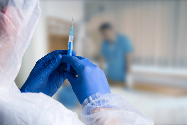close up of male doctor holding syringe with injection - Fotografie, Obrázek
