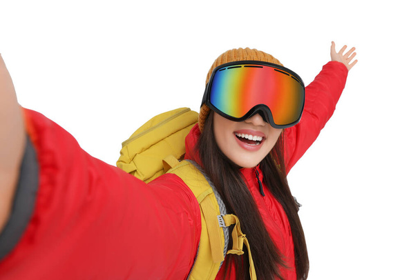 Smiling woman in ski goggles taking selfie on white background - Valokuva, kuva